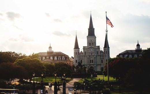St. Louis Cathedral rising above Jackson Square in New Orleans at dusk