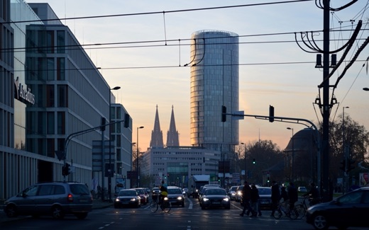 The spires of Cologne Cathedral and the KölnTriangle tower at dusk