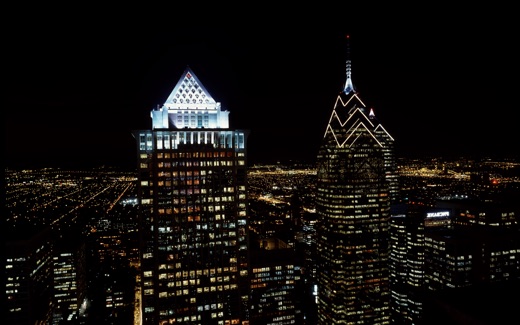 Philadelphia skyscrapers lit at night, with the spire of One Liberty Place