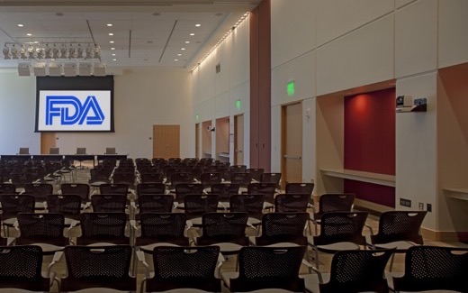 Rows of chairs facing an FDA-branded screen in the White Oak Great Room