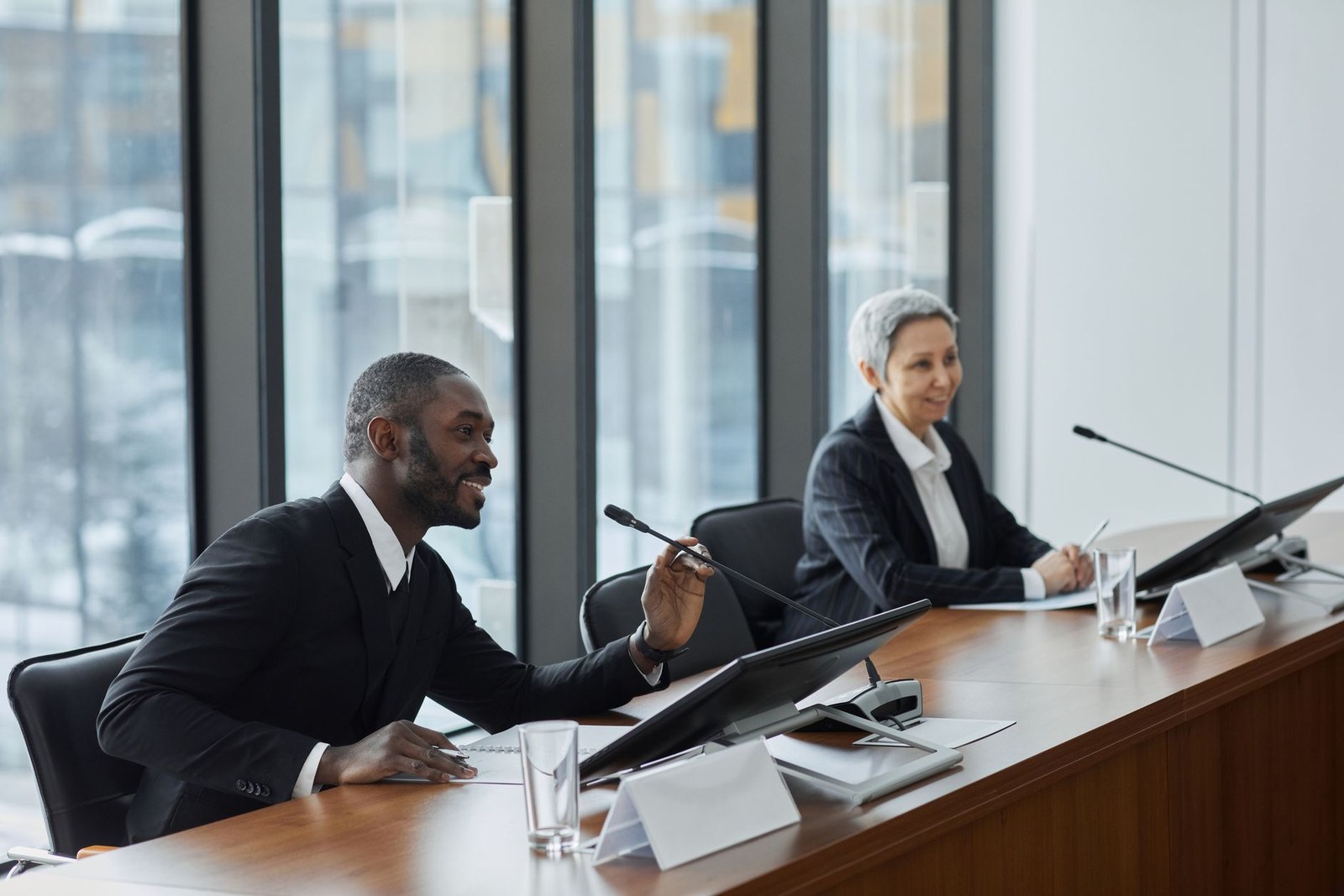 Panelists seated at a conference table answering questions during a legal and regulatory panel discussion