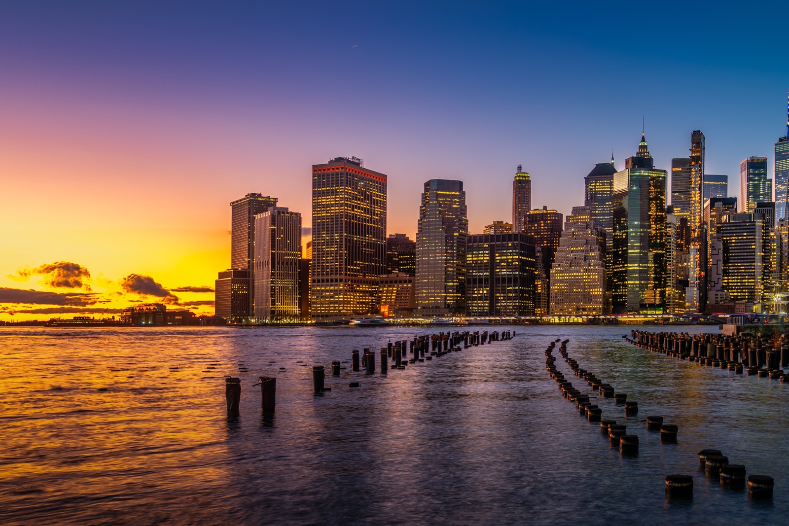 Lower Manhattan skyscrapers at sunset seen across the East River