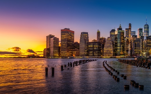 Lower Manhattan skyscrapers at sunset seen across the East River