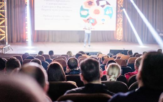 Delegates in an auditorium keynote at a medical technology conference